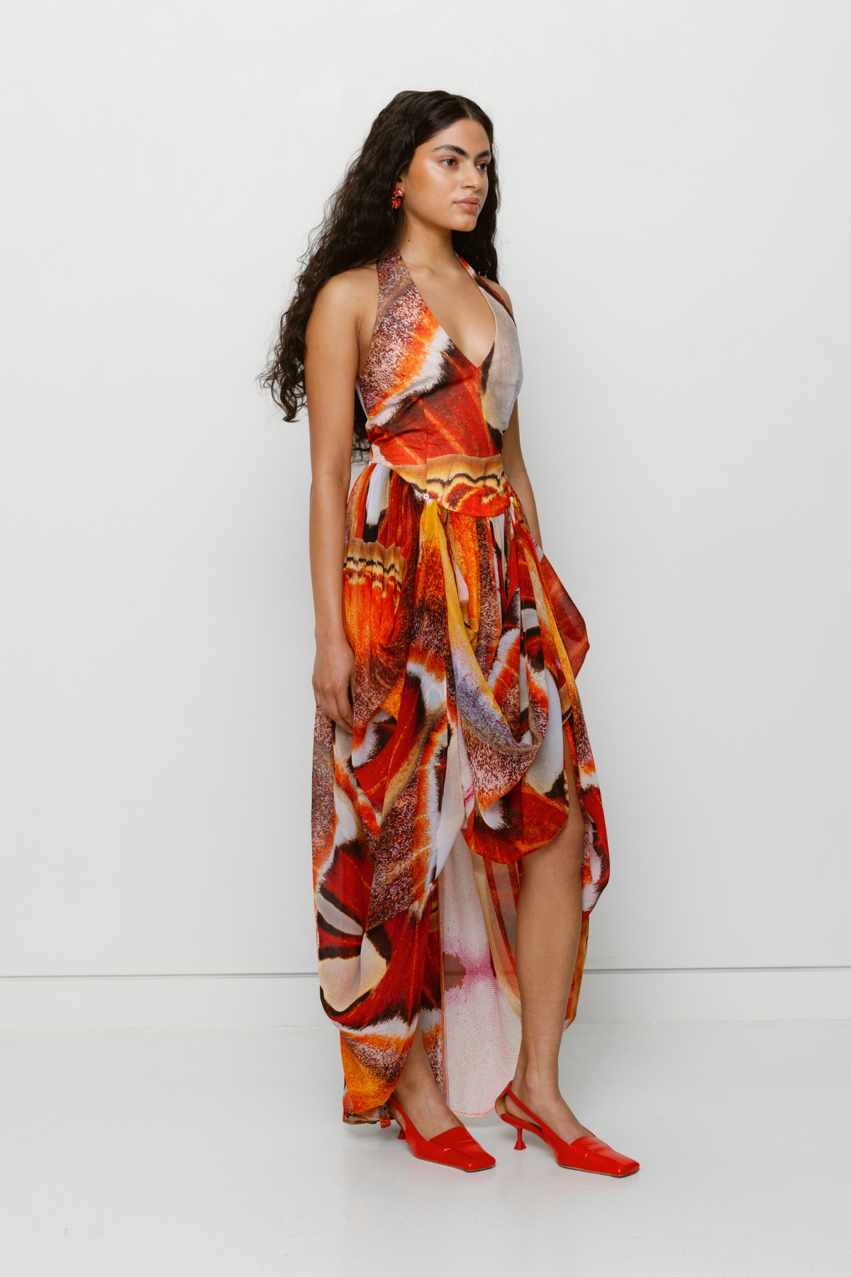 Versatile sheer Rumi Maxi Dress with adjustable skirt buttons by The Wolf Gang, customizable length for day or night wear.