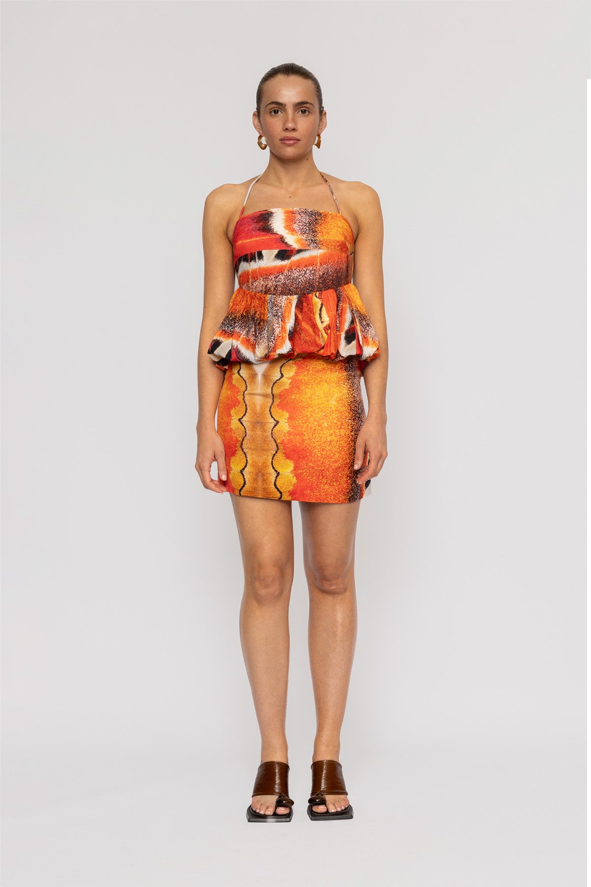 Orange multi-color linen mini skirt by The Wolf Gang, in custom TWG print, designed to pair with the Rumi Halterneck Top.