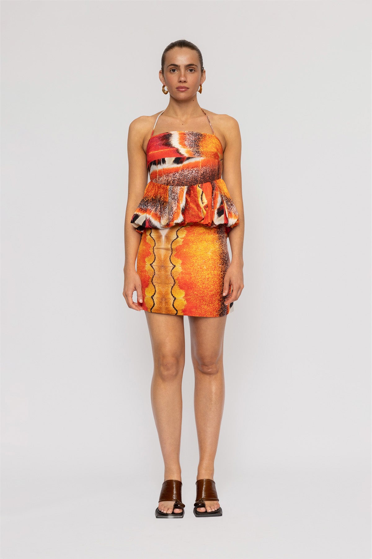 Orange multi-color halterneck blouse with bubble hem in custom TWG print by The Wolf Gang, pairs with matching skirt.