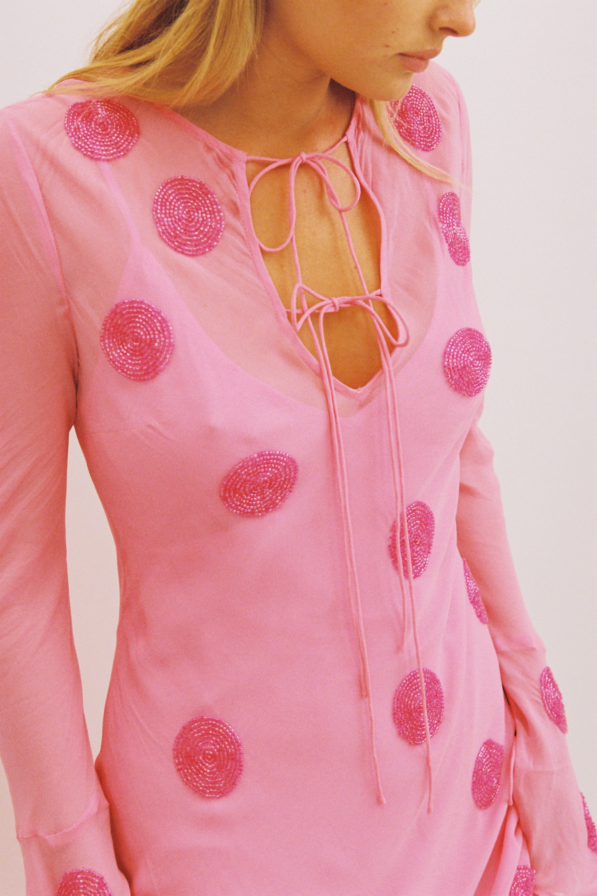 Beaded Sanja maxi dress with bell sleeves, tie details, and removable slip by The Wolf Gang, perfect for beach weddings.