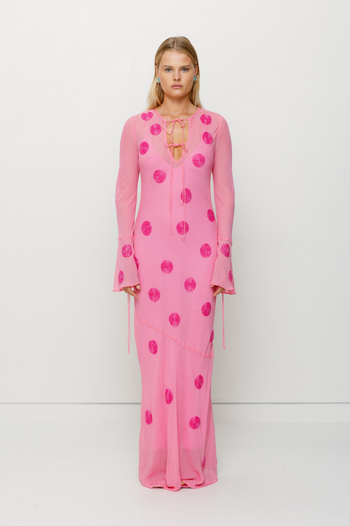 Beaded Sanja maxi dress with bell sleeves, tie details, and removable slip by The Wolf Gang, perfect for beach weddings.