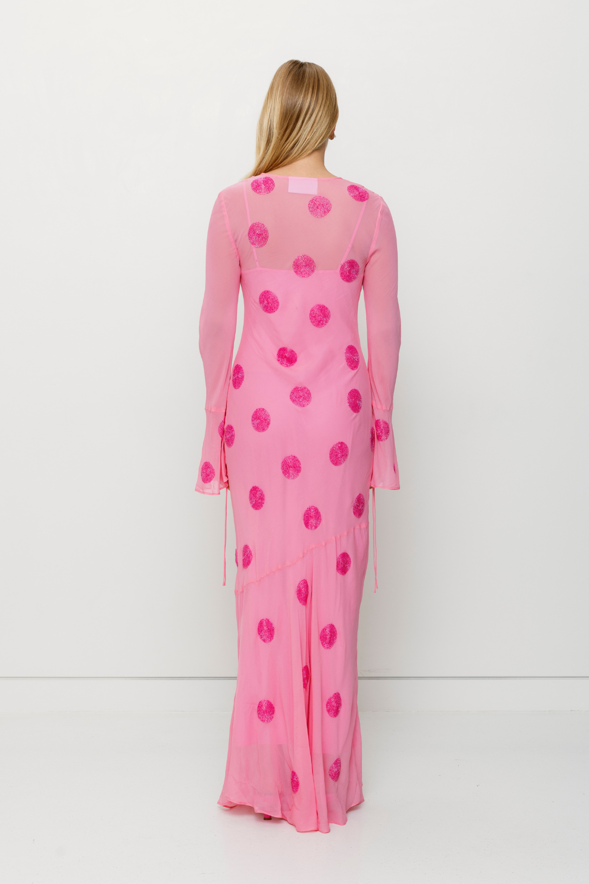 Beaded Sanja maxi dress with bell sleeves, tie details, and removable slip by The Wolf Gang, perfect for beach weddings.