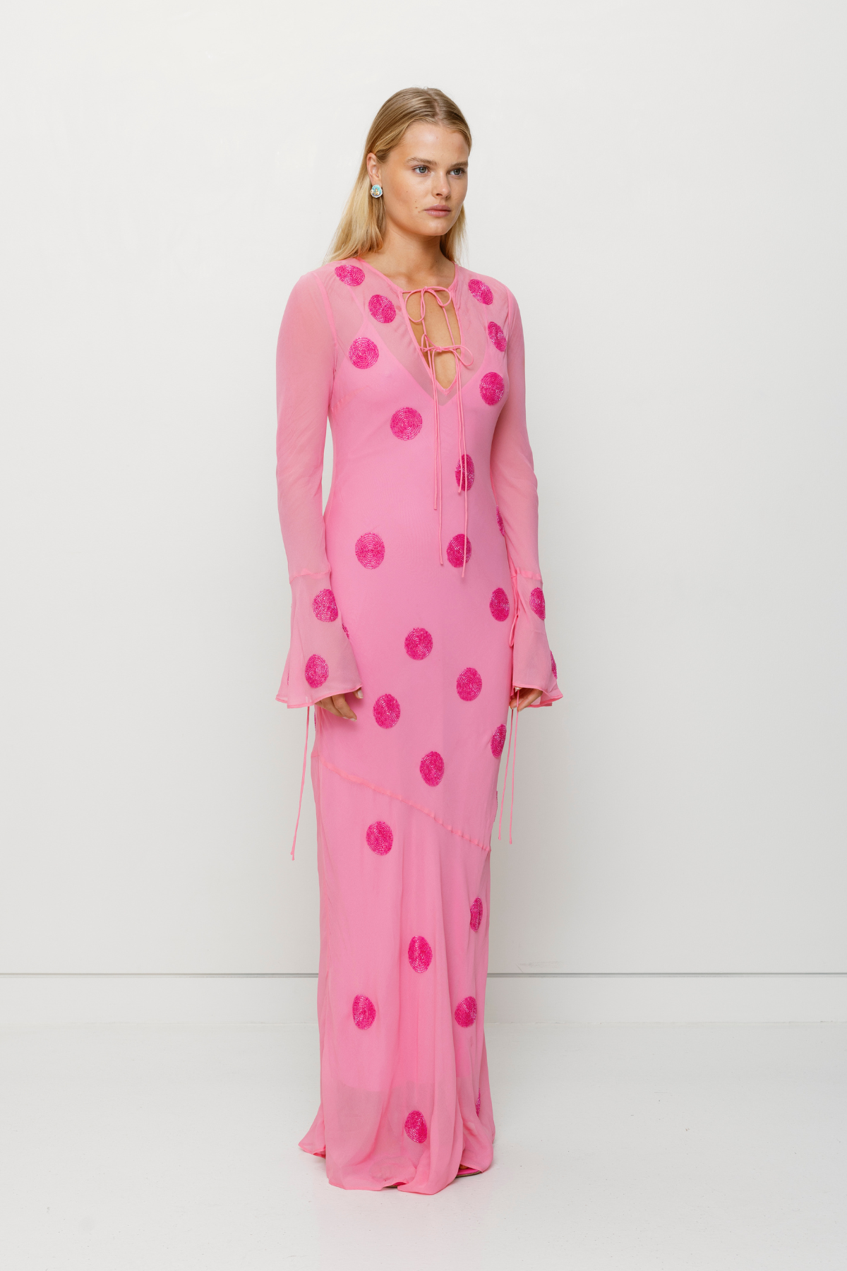 Beaded Sanja maxi dress with bell sleeves, tie details, and removable slip by The Wolf Gang, perfect for beach weddings.