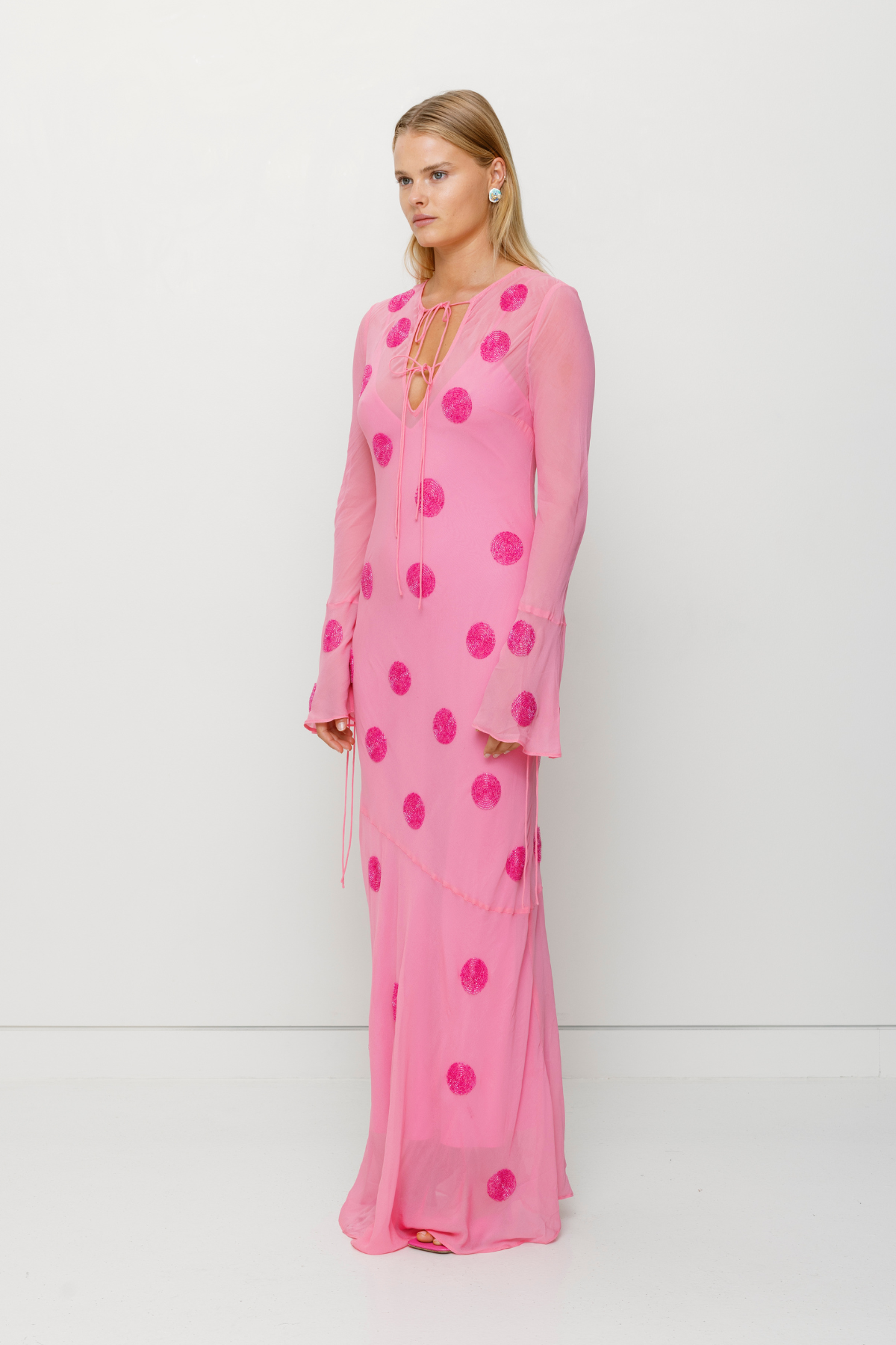 Beaded Sanja maxi dress with bell sleeves, tie details, and removable slip by The Wolf Gang, perfect for beach weddings.