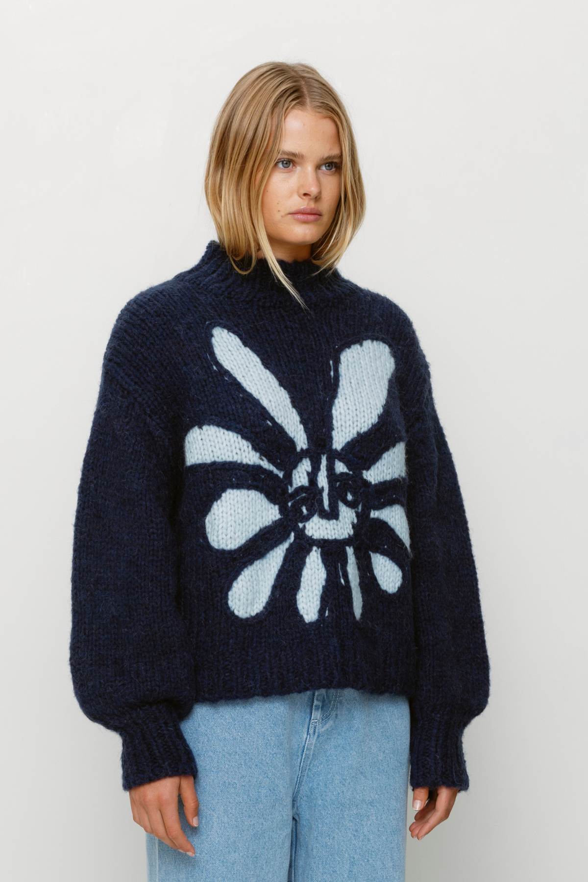 Cozy wool blend bell sleeve knit sweater with relaxed fit and custom TWG pattern, perfect for stylish winter layering.