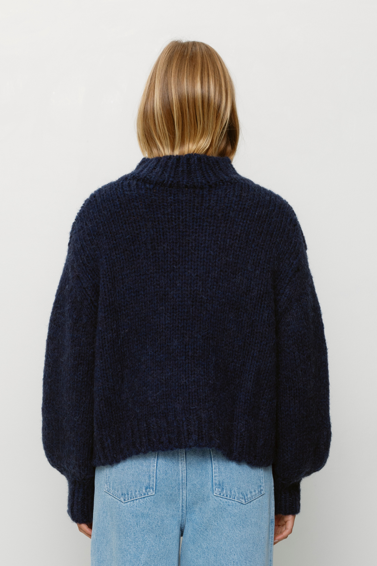 Cozy wool blend bell sleeve knit sweater with relaxed fit and custom TWG pattern, perfect for stylish winter layering.