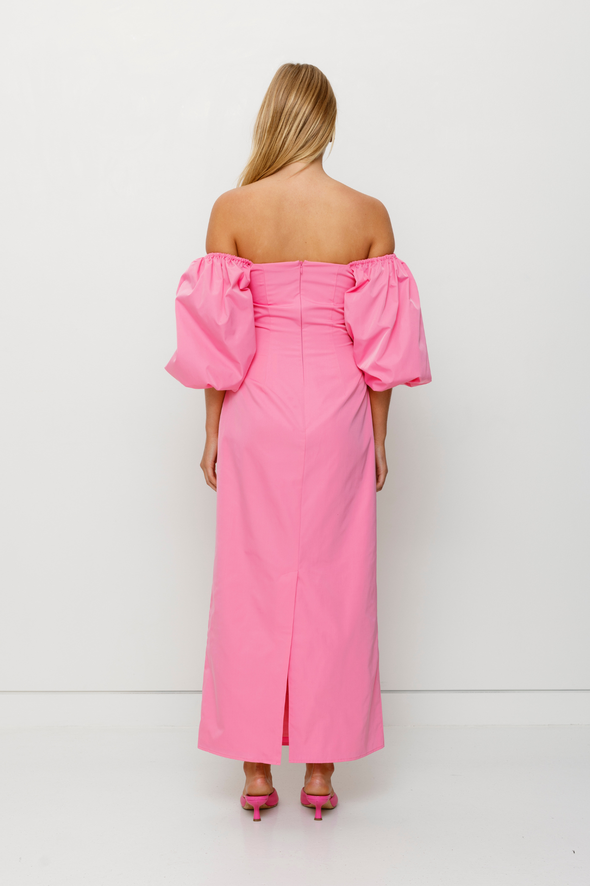 Mid-length off-shoulder dress with elasticated puff sleeves and velvet bow detail by The Wolf Gang, in pink, red, and black.