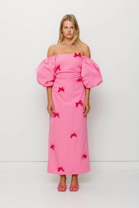 Mid-length off-shoulder dress with elasticated puff sleeves and velvet bow detail by The Wolf Gang, in pink, red, and black.