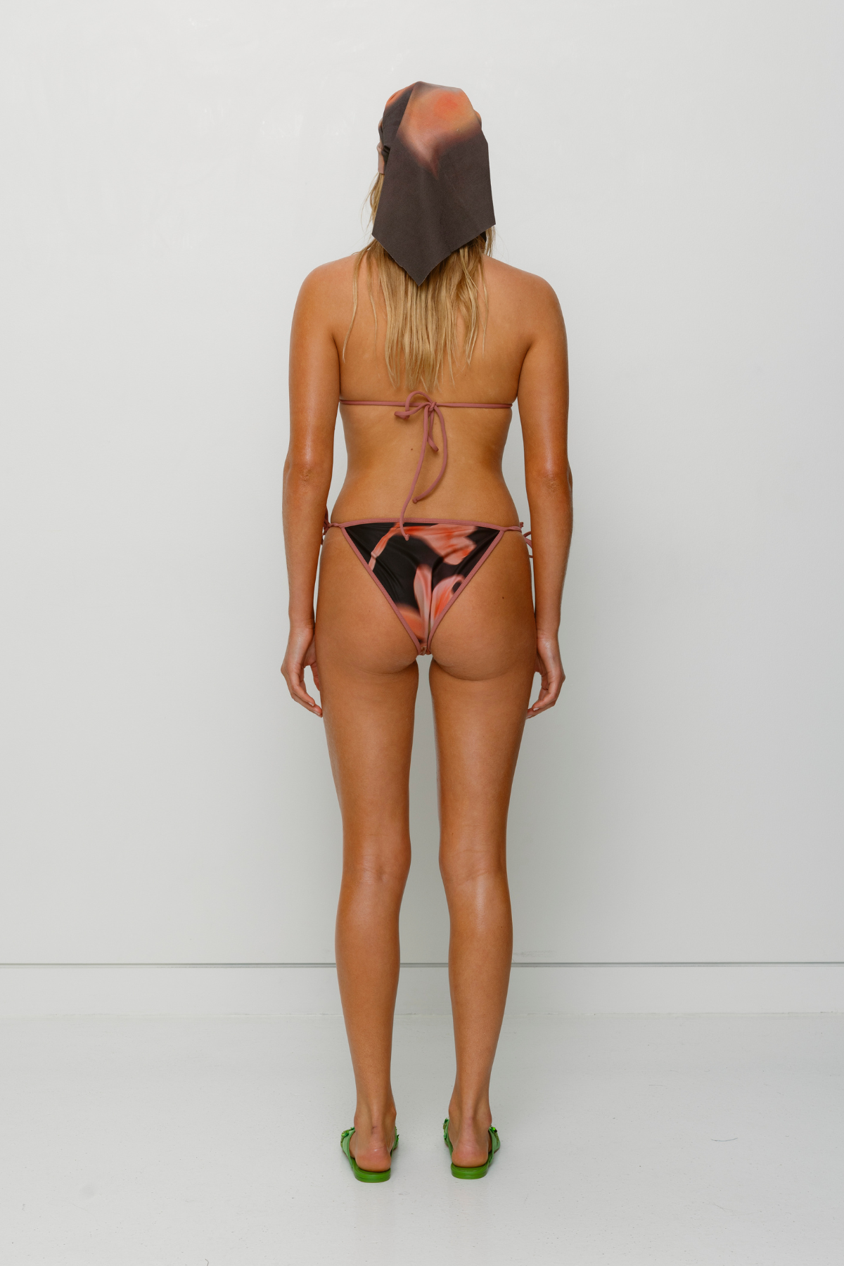 Brown floral triangle bikini set with beaded drawstrings and adjustable ties by The Wolf Gang, perfect for summer getaways.