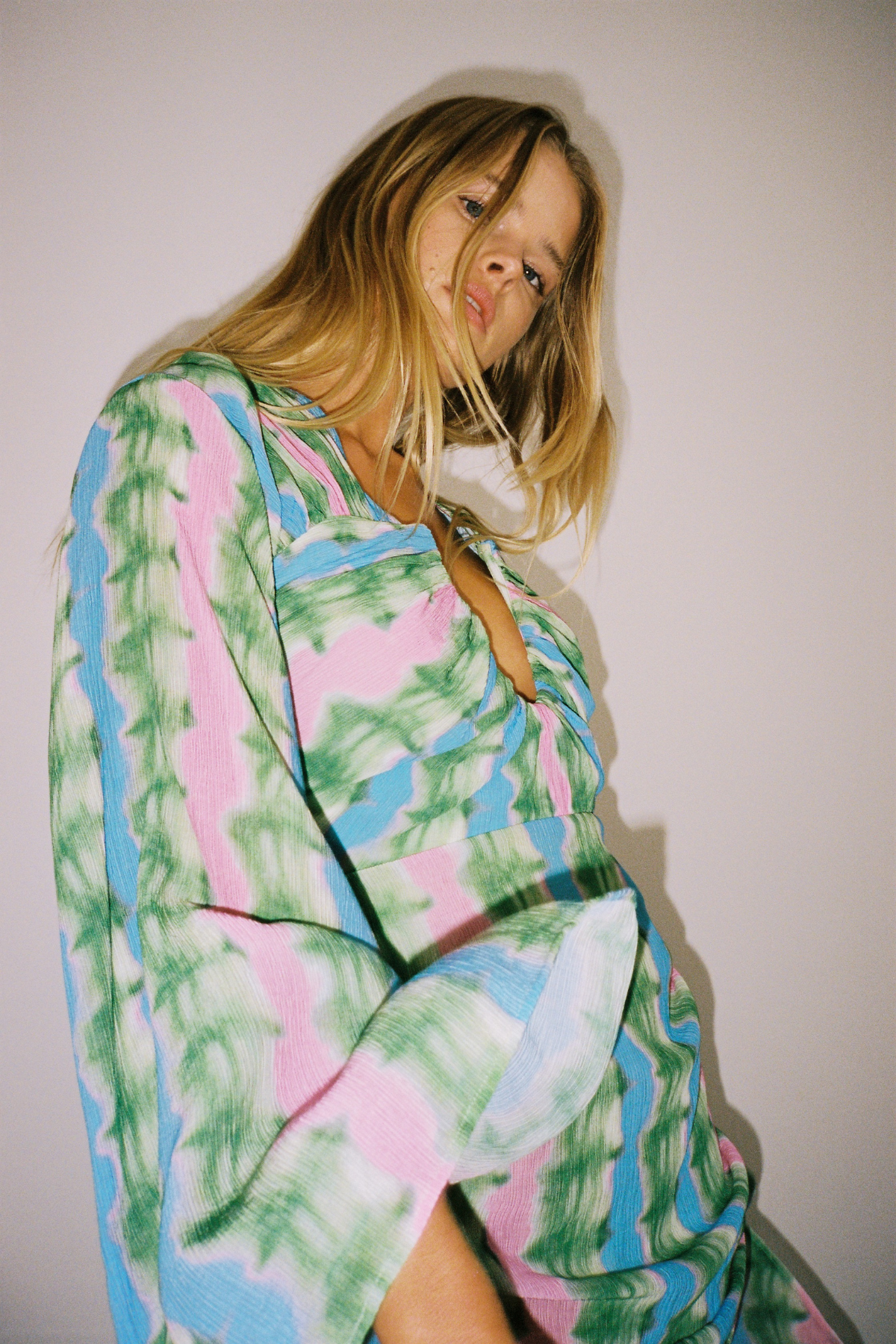 Women's tie-dye mini dress with ruched skirt and cape sleeves by The Wolf Gang, perfect for parties and nights out.