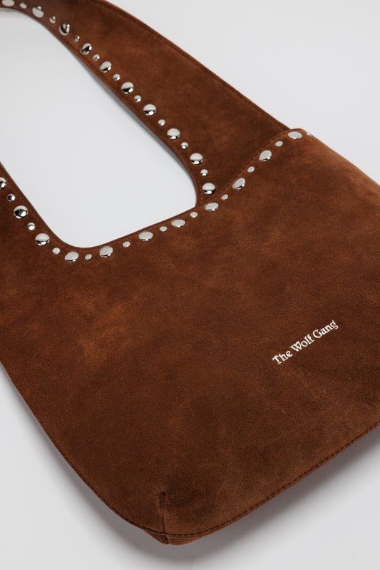 Luxe suede leather shoulder bag with magnetic closure and silver accents.