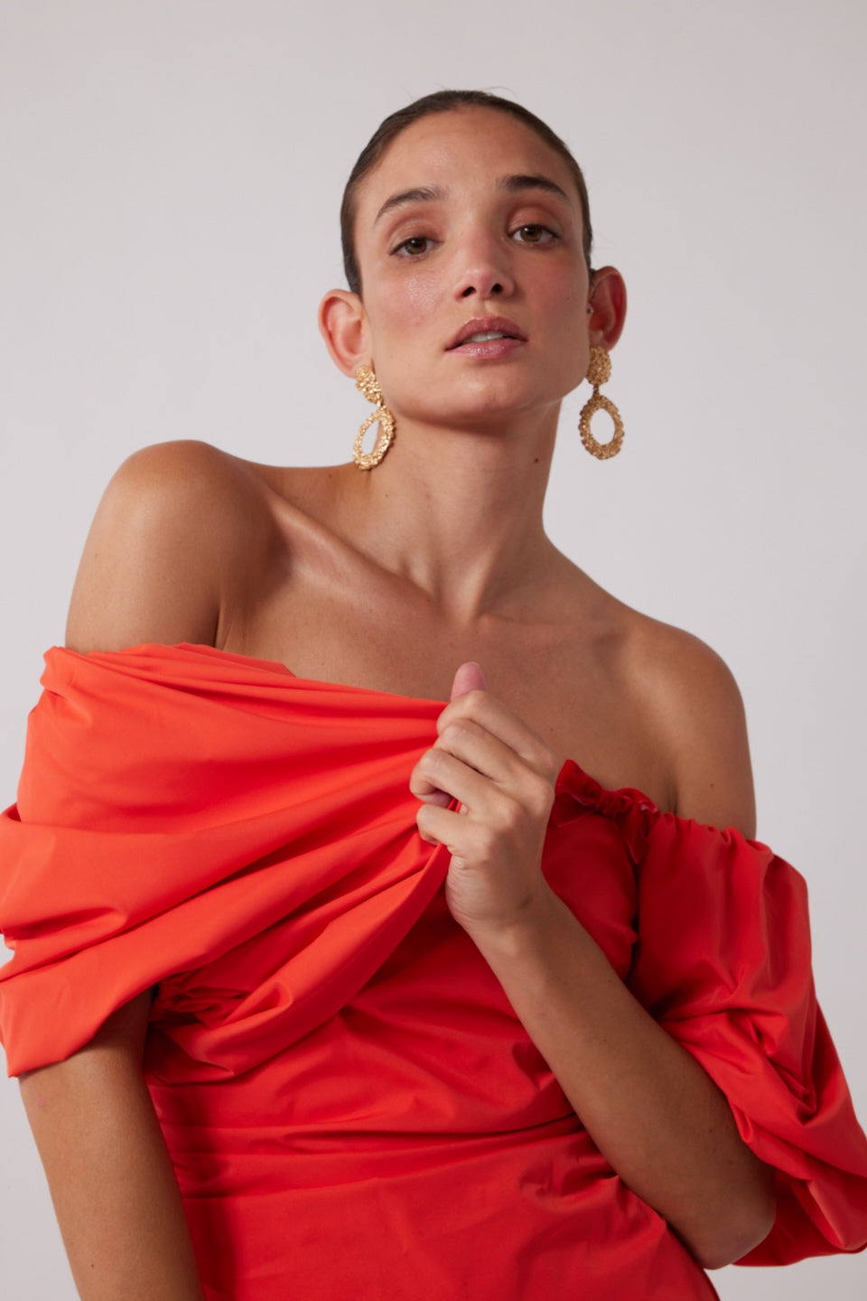 Mid-length off-shoulder dress with elasticated puff sleeves and velvet bow detail by The Wolf Gang, in pink, red, and black.