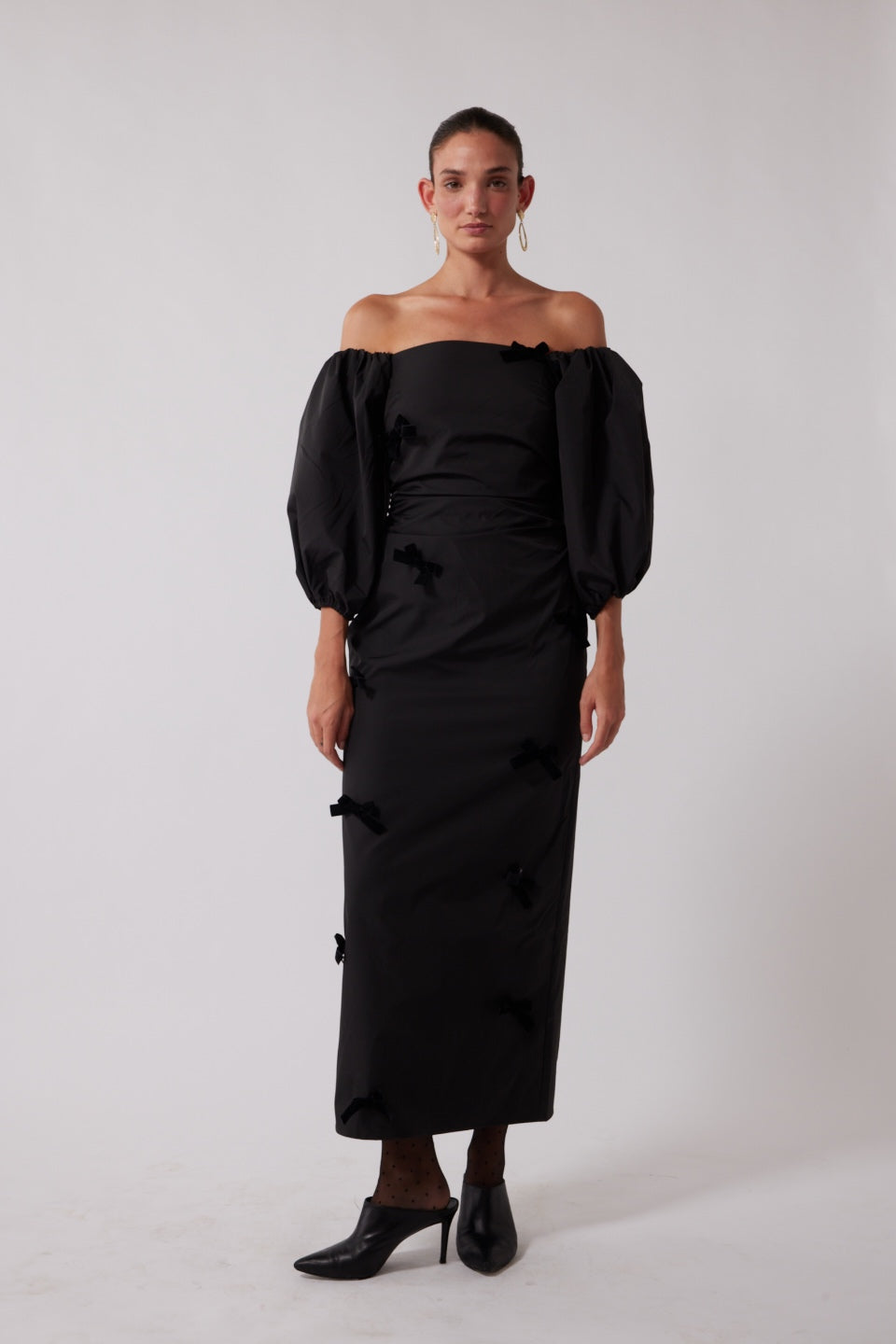 Mid-length off-shoulder dress with elasticated puff sleeves and velvet bow detail by The Wolf Gang, in pink, red, and black.