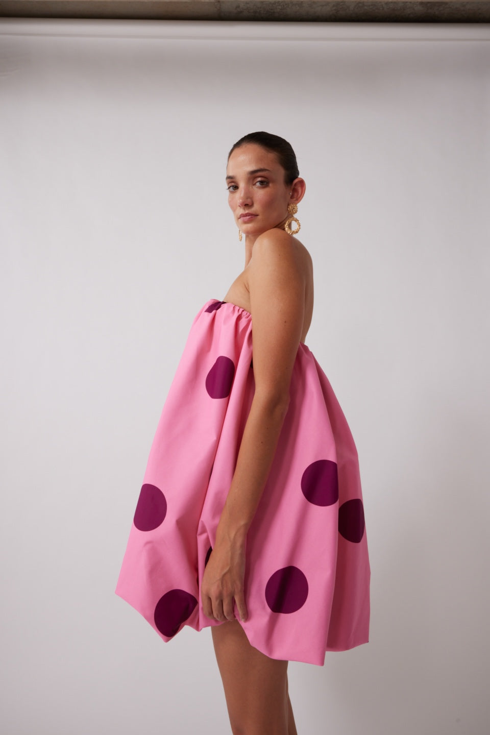 Womenâs spotted mini dress with bubble hem, back zip, and internal bra support.