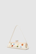 Handbag with colourful gemstone embellishments on a light grey background