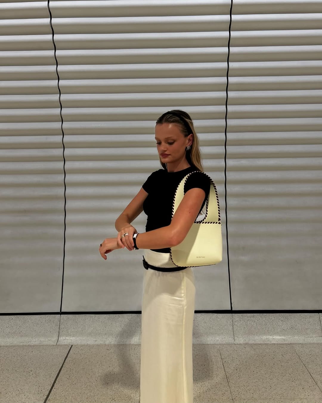 Maddie wears the Mara Shoulder Bag in Creme