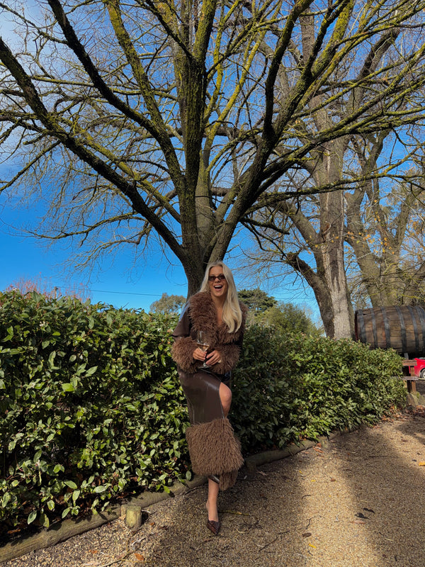 Dani wears the Abrigo Coat in size S