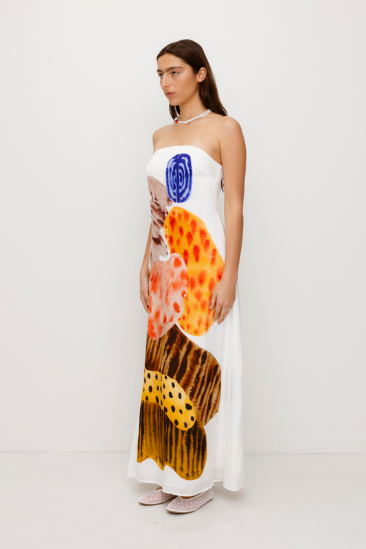 Women’s strapless White Kora Maxi Dress with asymmetric cowl neckline, abstract print, and invisible zip—perfect for events or long lunches.