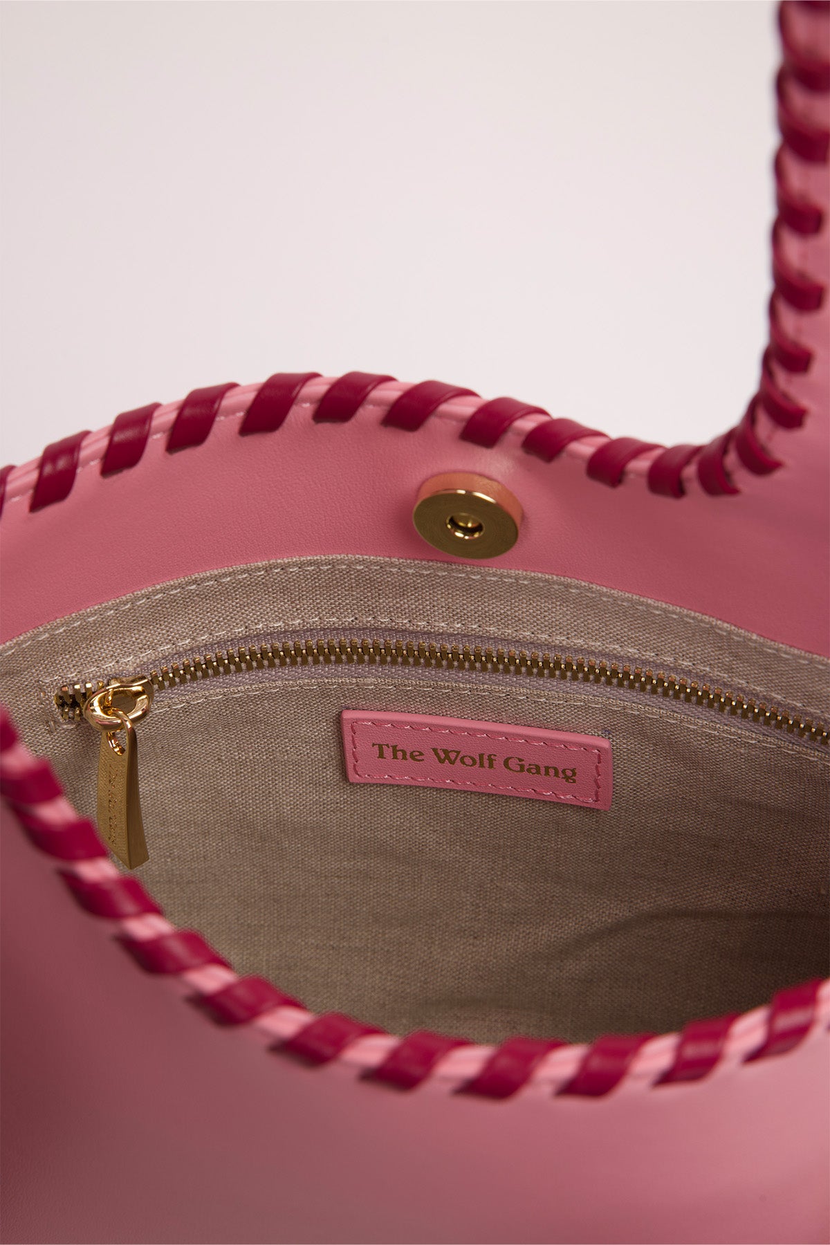 Women’s Candy Pink Mara Shoulder Bag in 100 percent leather with twisted strap contrast binding and magnetic snap closure for everyday wear.