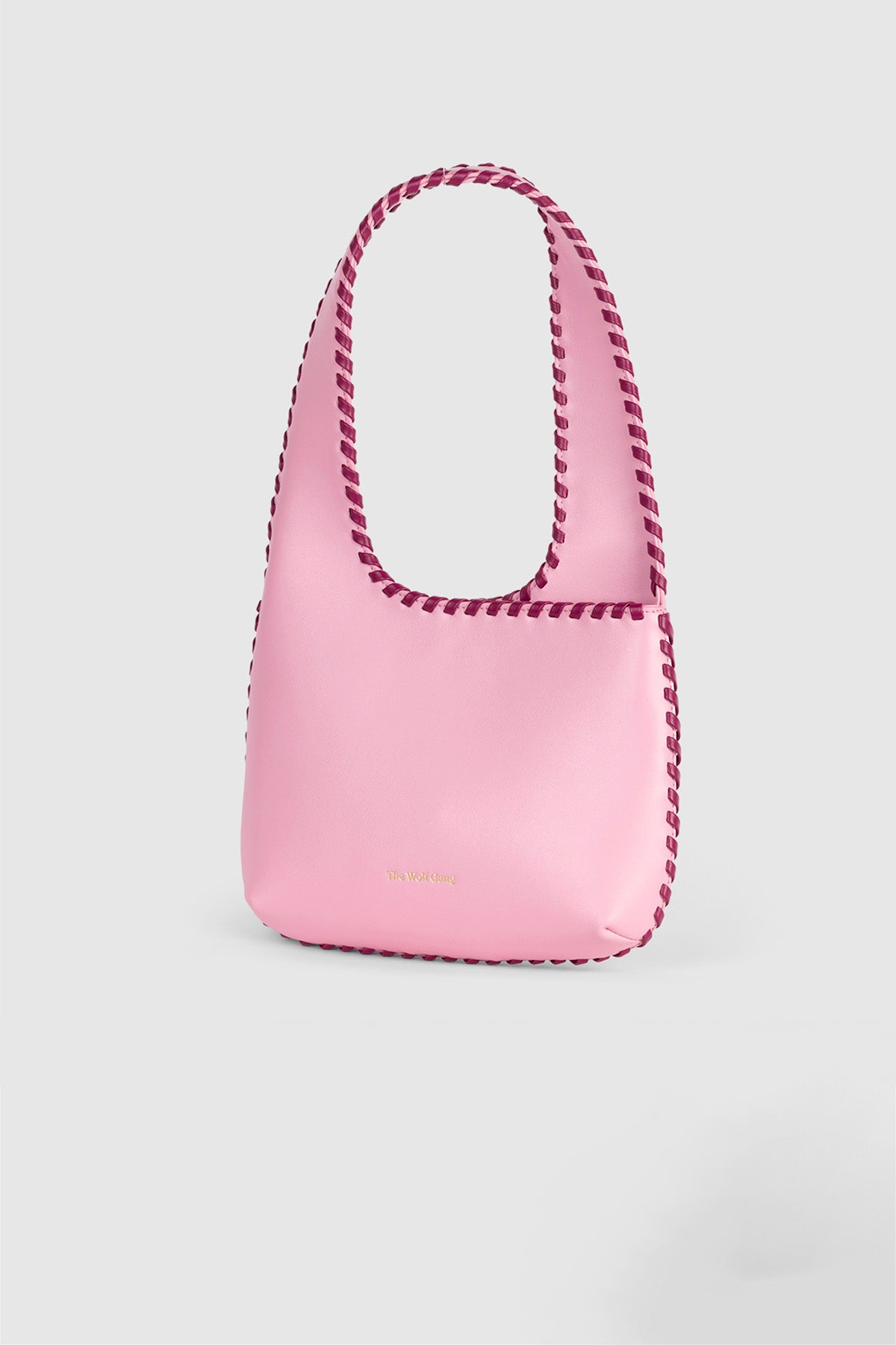Women’s Candy Pink Mara Shoulder Bag in 100 percent leather with twisted strap contrast binding and magnetic snap closure for everyday wear.