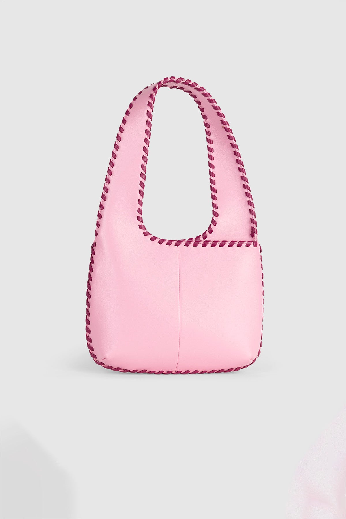 Women’s Candy Pink Mara Shoulder Bag in 100 percent leather with twisted strap contrast binding and magnetic snap closure for everyday wear.