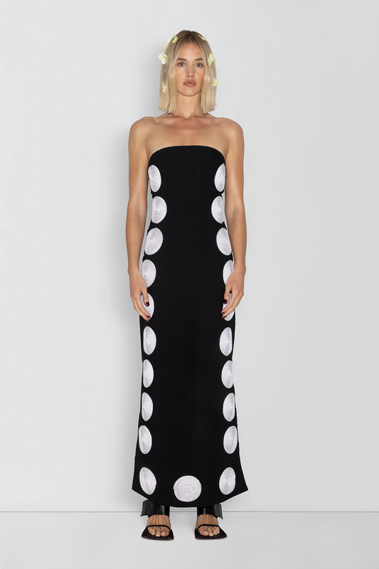 Woman wearing black linen cotton maxi dress with contrast embroidery and shaped bust.