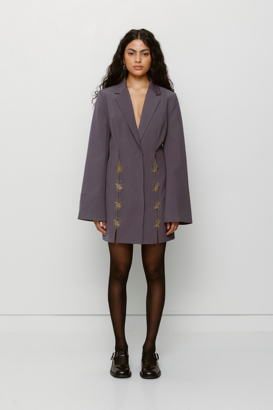 Long-sleeve mini blazer dress with custom hardware and peek-a-boo cutouts by The Wolf Gang, perfect in butter yellow or charcoal grey.