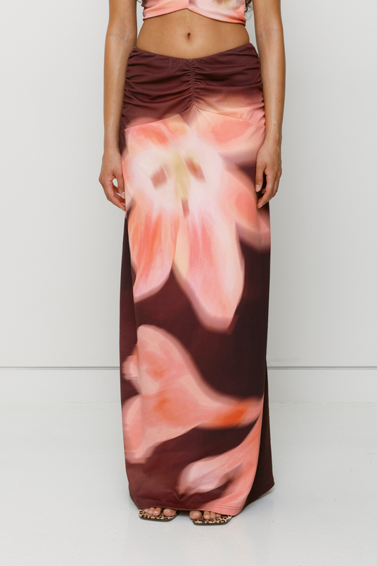 Brown floral print ruched maxi skirt with figure-hugging fit by The Wolf Gang, pairs with matching Veda Top for an event-ready look.