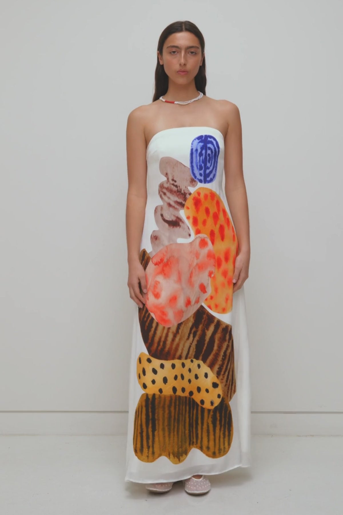 Women’s strapless White Kora Maxi Dress with asymmetric cowl neckline, abstract print, and invisible zip—perfect for events or long lunches.