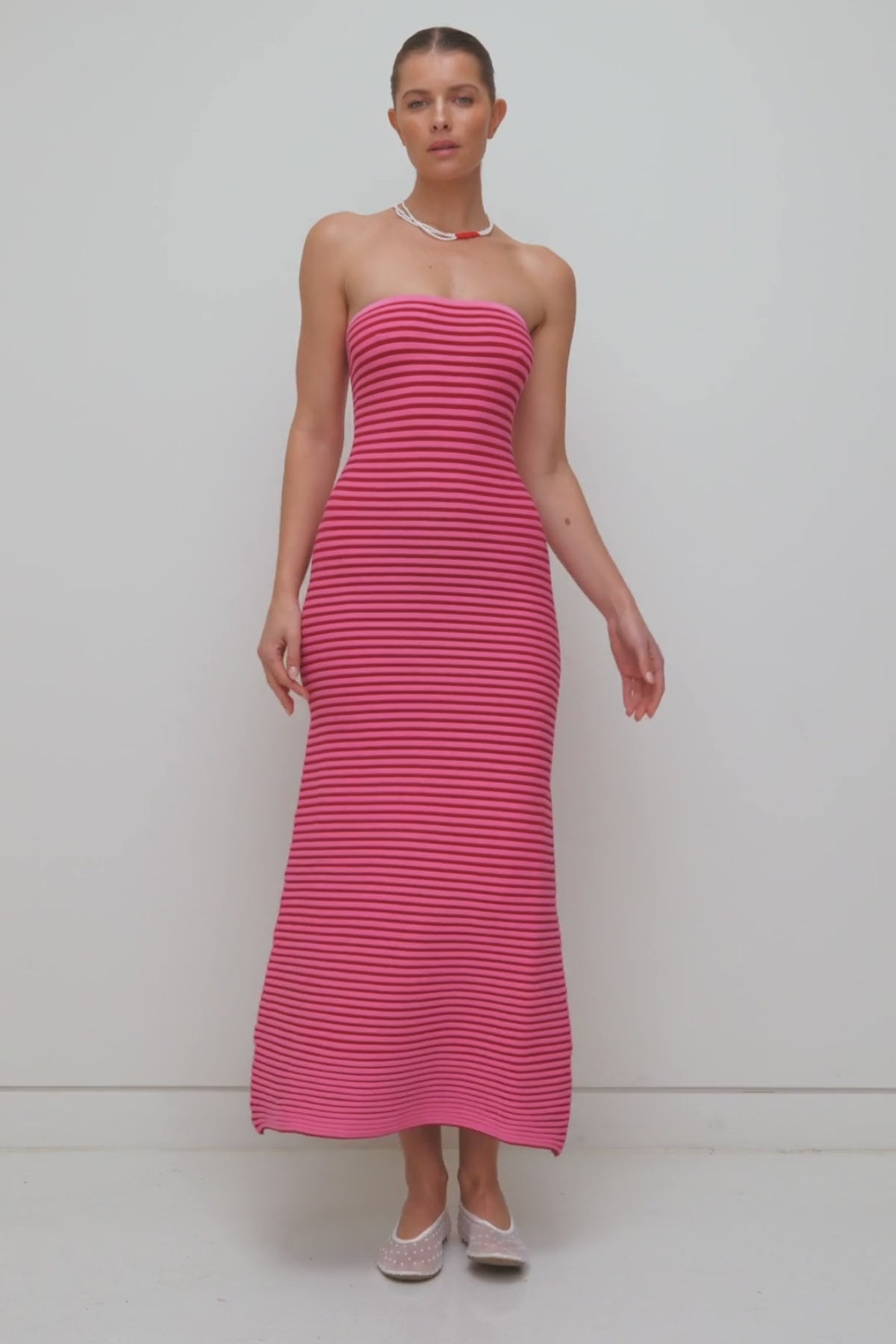 Pink strapless tonal stripe knit maxi dress with body-con fit, perfect for maternity or event wear.