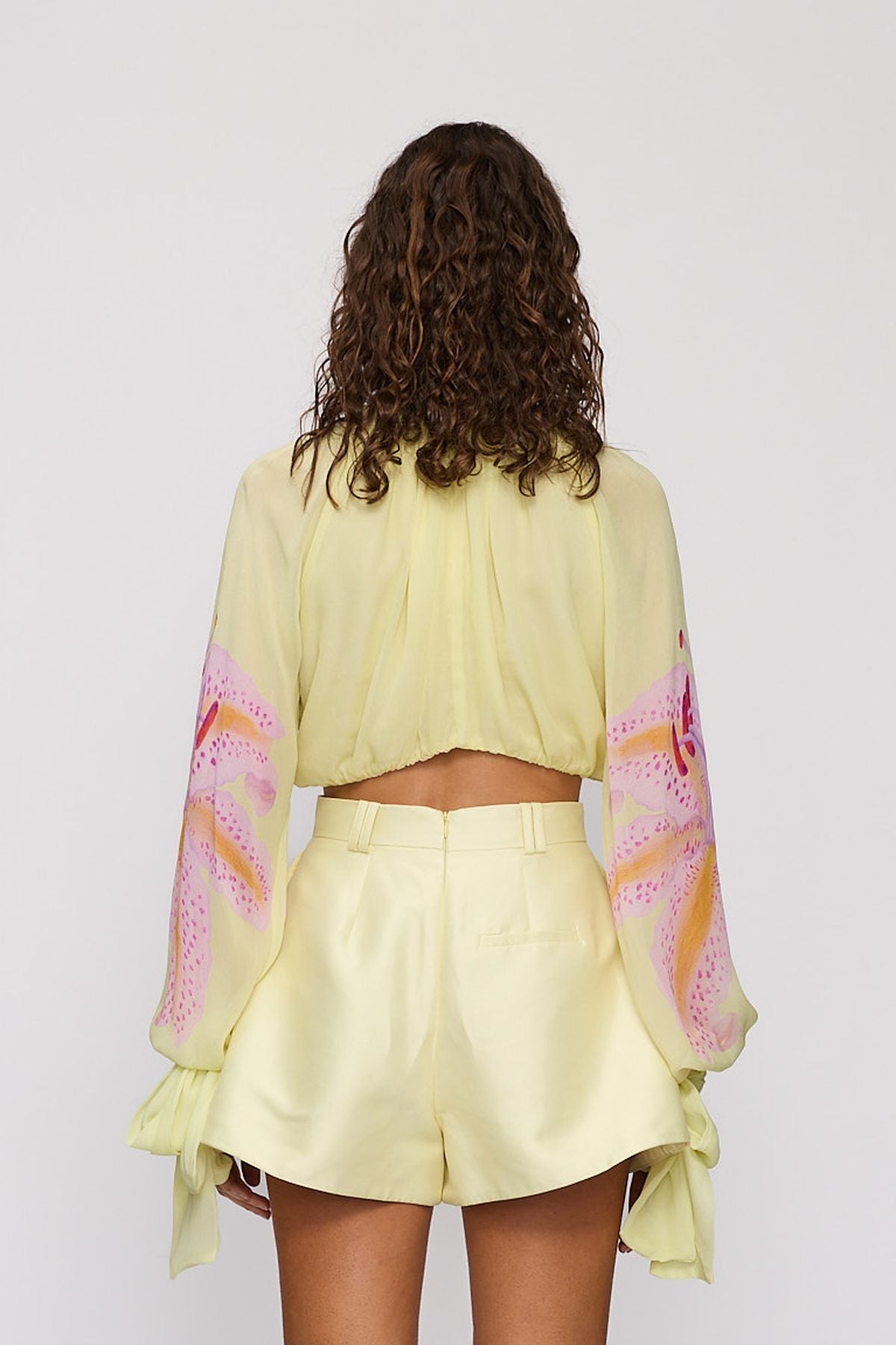 Celia Blouse in Candy Hibiscus by The Wolf Gang – back close-up showing elasticated hem
