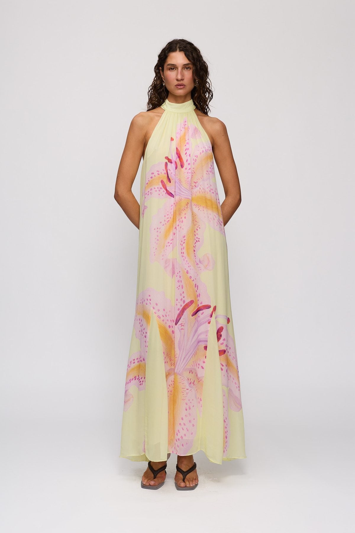 Celia Maxi Dress in Candy Hibiscus by The Wolf Gang – front view, hands behind