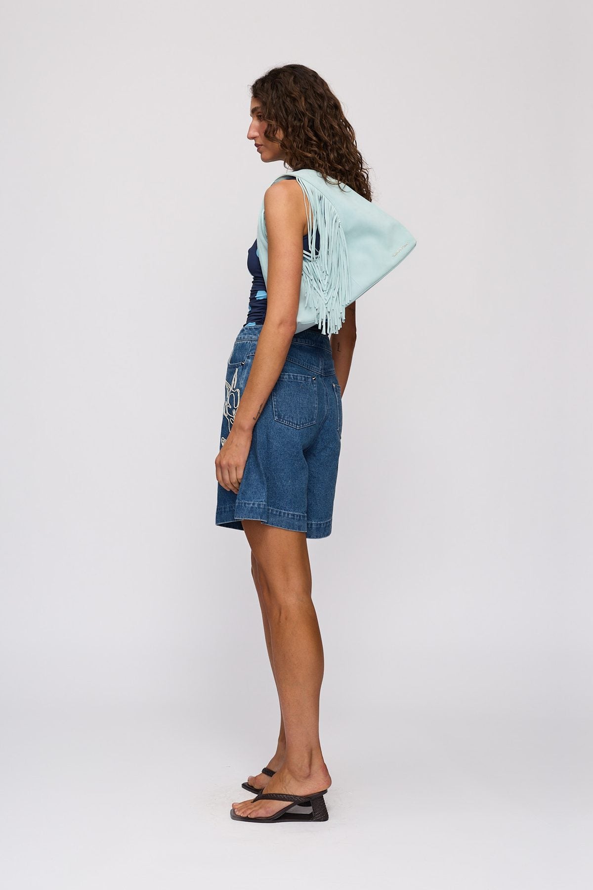 Novia Fringe Handbag in Sky by The Wolf Gang – styled back view, worn on shoulder