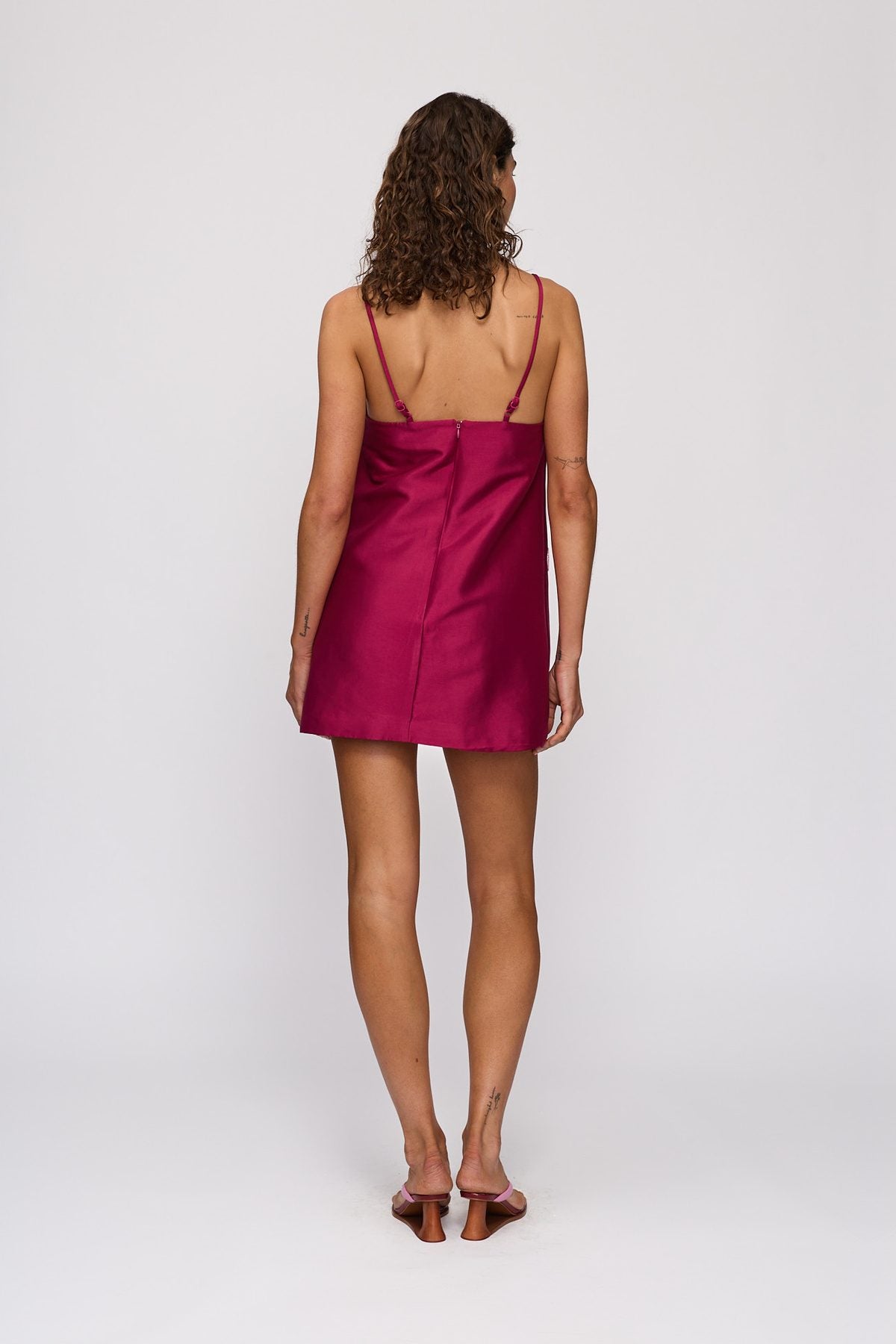 Palma Mini Dress in Berry by The Wolf Gang – back view, hands behind