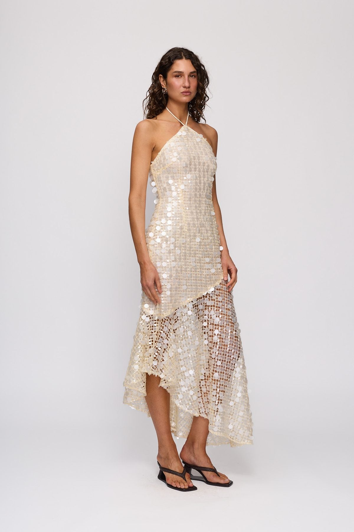 Sondra Maxi Dress in Champagne by The Wolf Gang – front view showing asymmetric hem