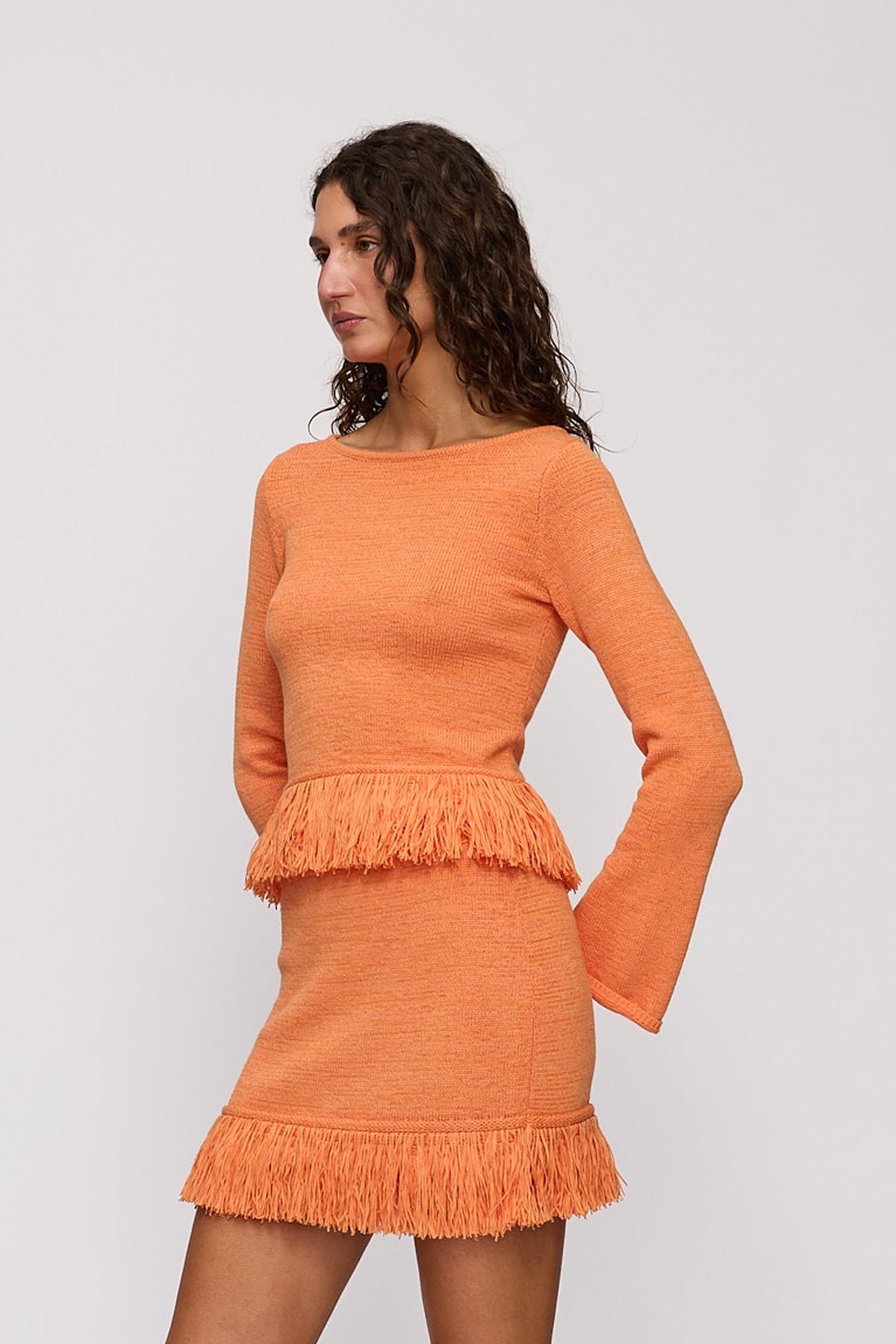 Tully Long Sleeve in Tangerine by The Wolf Gang – side close-up showing flared sleeve