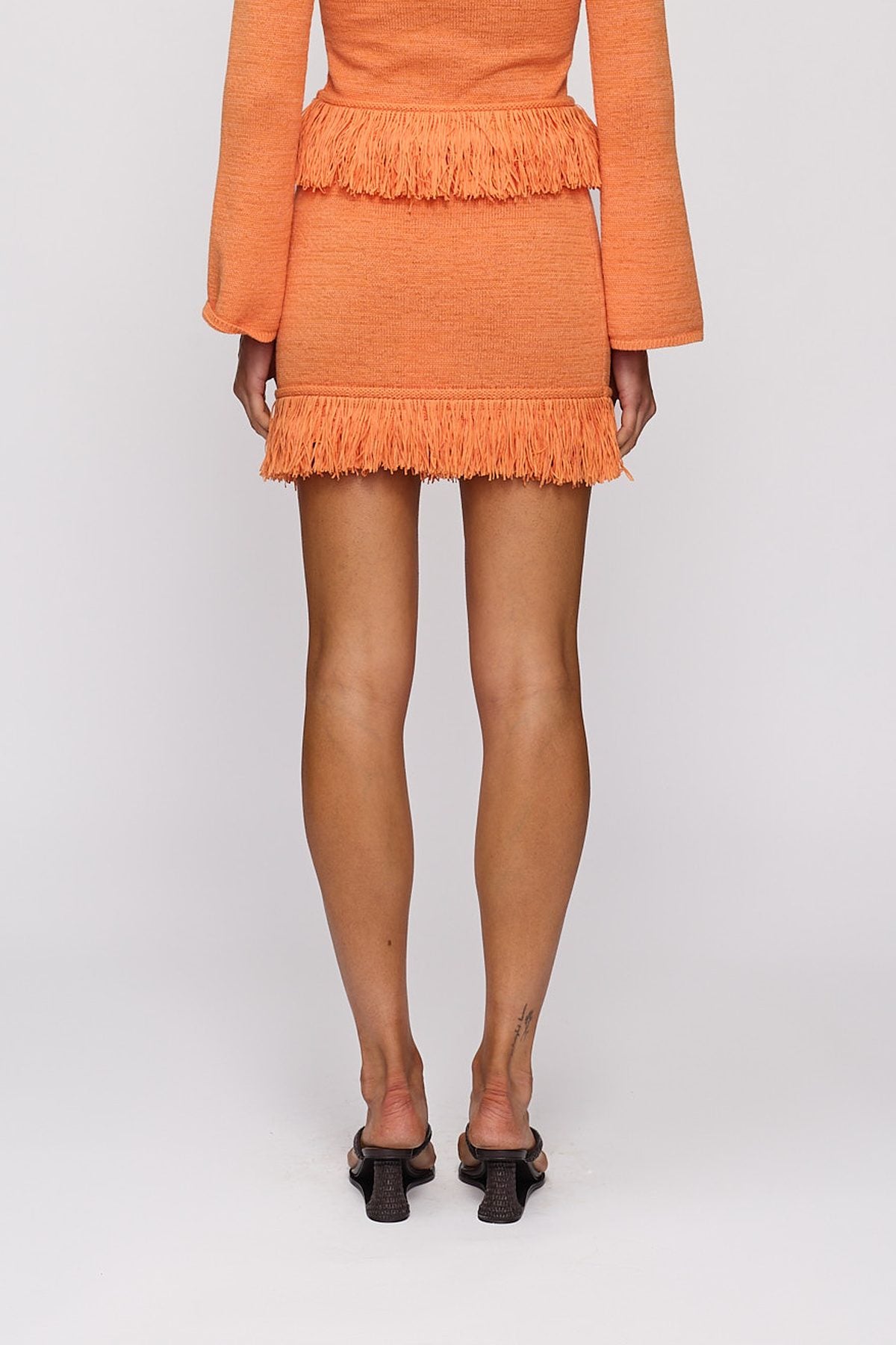 Tully Mini Skirt in Tangerine by The Wolf Gang – close-up view